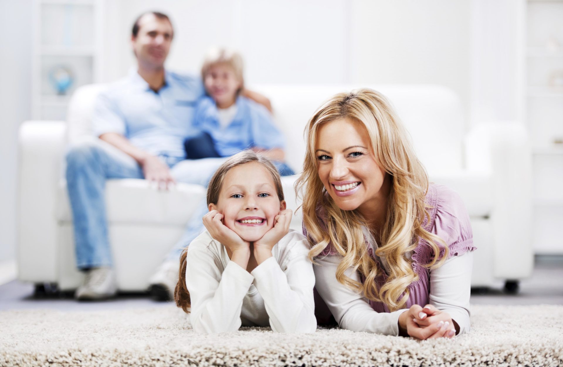 704397.family-on-carpet-and-couch-e1550075237460